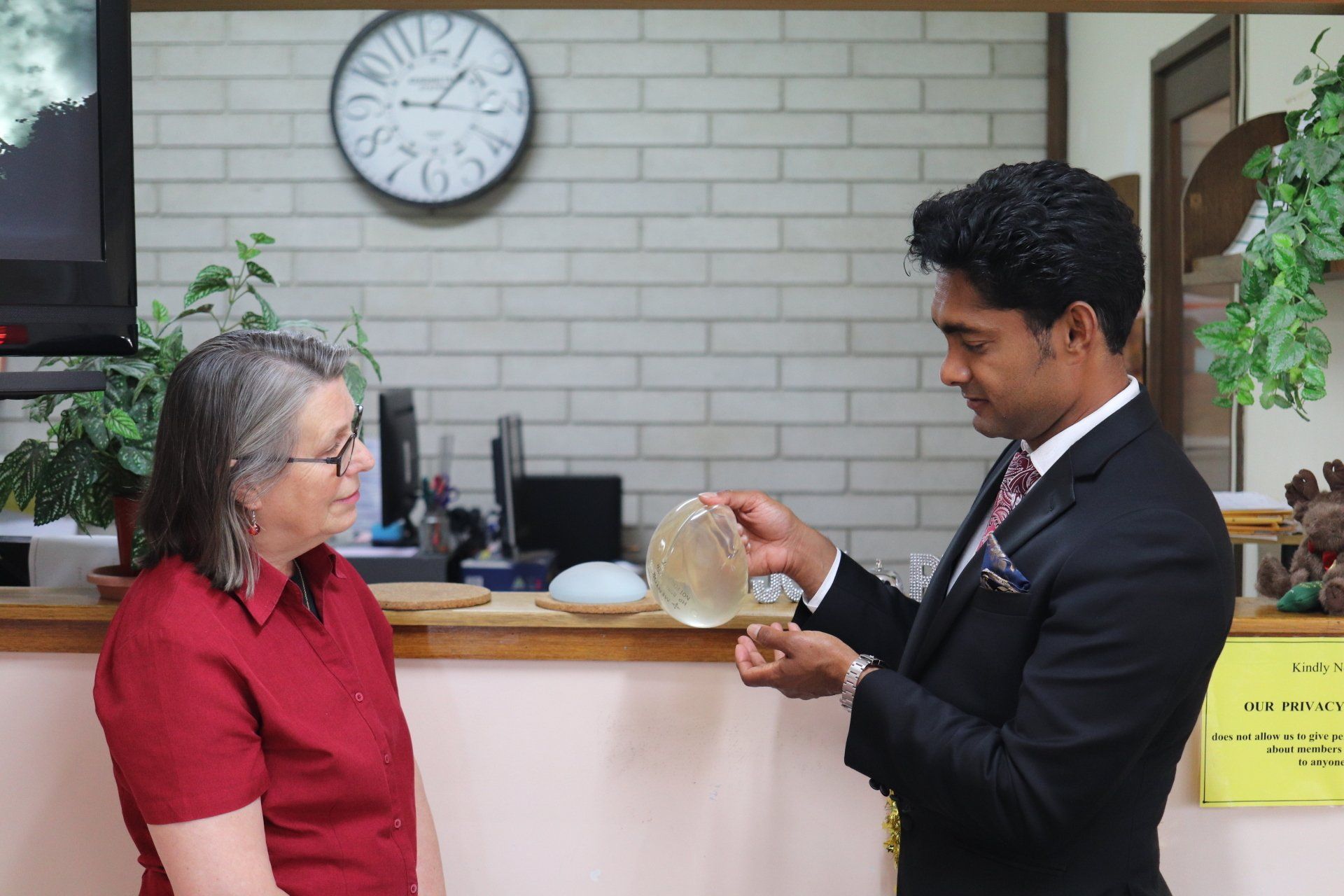 Dr Kishen Nara discussing a breast implant in consultation with a patient at the RevAesthetic clinic